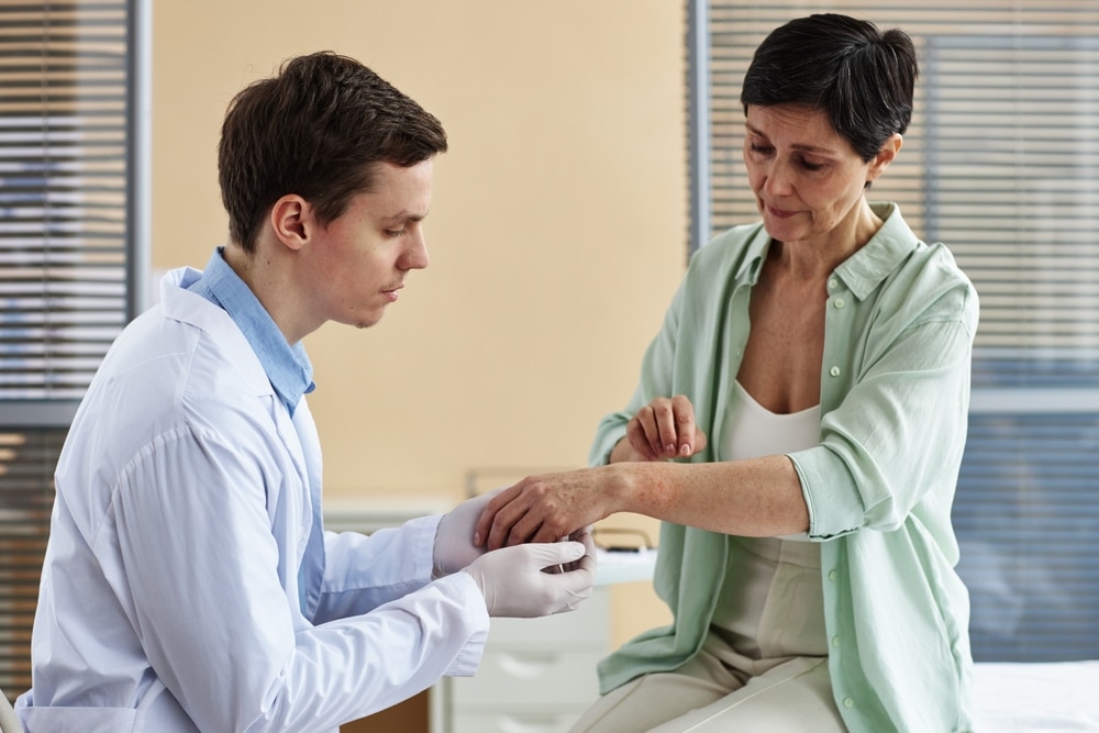 doctor examining hands of mature woman Psoriasis and Psoriatic Arthritis Treatment in Dover Delaware